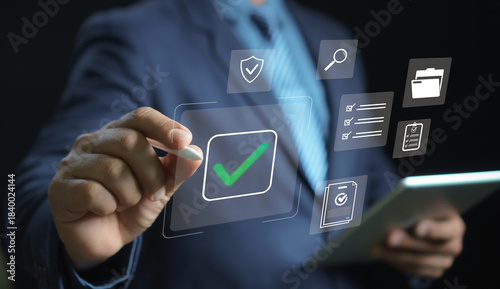Digital checklist and approval concept. businessman selec virtual checkmark icon surrounded by security, documents, tasks, and verification symbols, emphasizing workflow management and productivity.