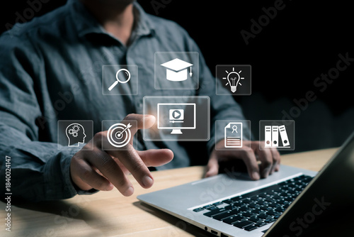 Modern digital learning concept with a person using a laptop and virtual icons for education, research, video, innovation, and knowledge management in an online technology environment.