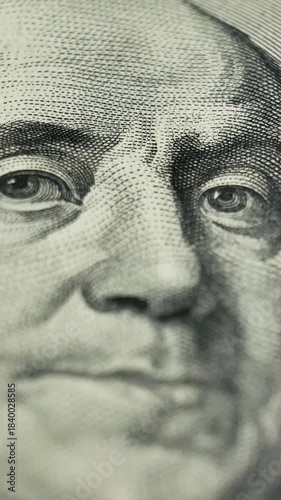 Close up of 100 dollar bill featuring Benjamin Franklin portrait. Money used for settling both public and private debts. Deposit money used in banking and financial systems