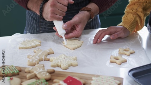 parent is decorating tree-shaped sugar cookie in flat design style, food theme featuring piping bag