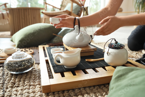 Asian woman with black tea ...