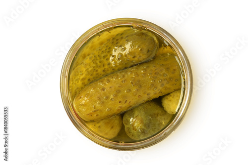Top view of pickled cucumbers in glass jar on white background