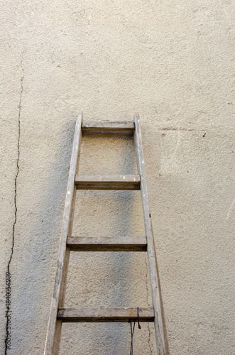 Old ladder leaning against the wall