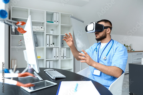 Male doctor using VR glasse...