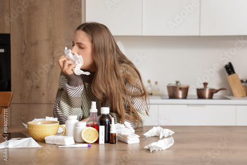 Sick young woman with tissu...