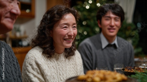 Asian family gathers warmly under twinkling fairy lights, celebrating Hoonko with savory bites and familial laughter