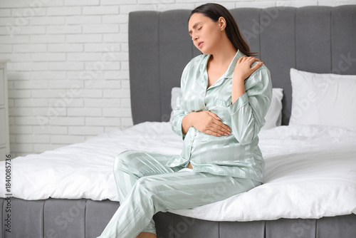 Pregnant young woman in paj...