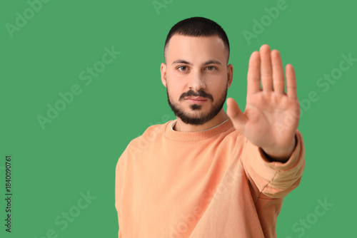 Young man showing STOP gest...