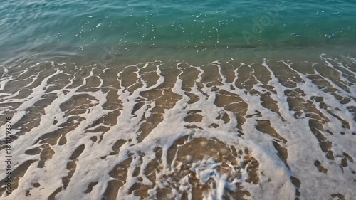 Waves Washing Seashells on Sandy Beach - Coastal Serenity Video.