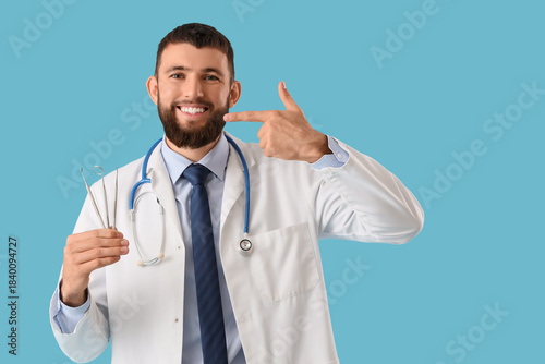 Happy male dentist with pro...