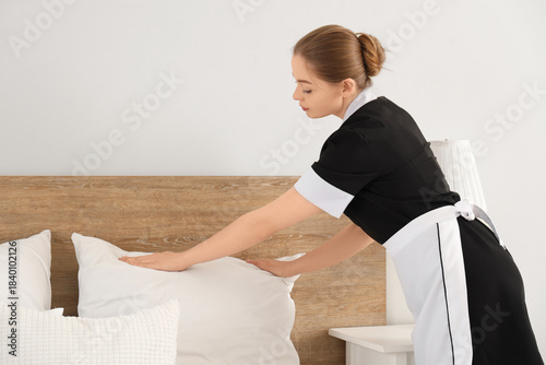 Young chambermaid making be...