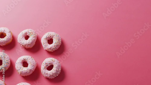 Pink donut cluster staying left while gold confetti bursting from right and drifting over for promo