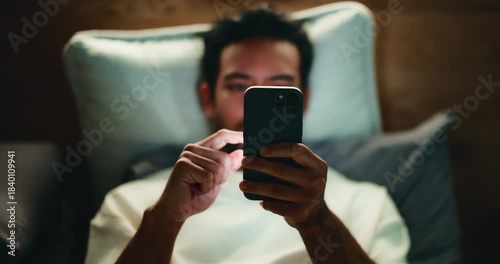 Phone, night and man in bedroom with insomnia, search and social media for relax with top view. Home, bed and sleepless person with mobile for notification, doom scroll and internet addiction above