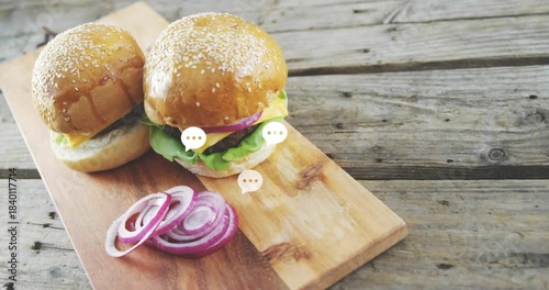 Two cheeseburgers on wooden board, chat bubbles coming from right, clustering fading creating buzz
