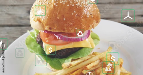 Green icons fading in from edges floating over sesame burger camera pulling back revealing eco cost