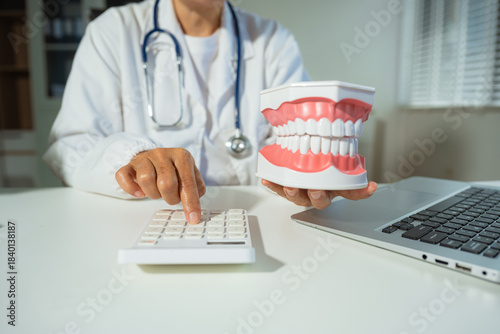 dentists with calculate medical fee costs & revenue. practitioner use calculator at clinic.