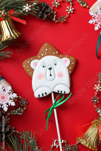 Gingerbread polar bear on red holiday background. Happy New Year. Greeting card