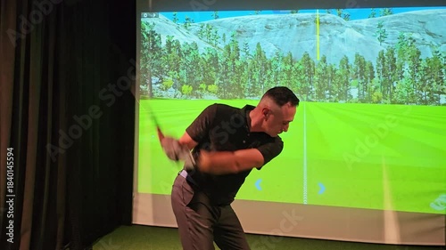 Golf swing practice in indoor simulator with realistic landscape and detailed graphics