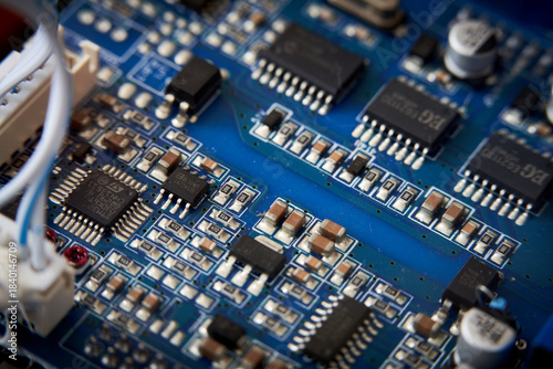 Close up of electronic circuit board with microchips and capacitors