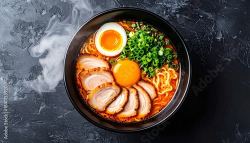 Delicious hot ramen bowl with soft boiled eggs, pork slices and green onions
