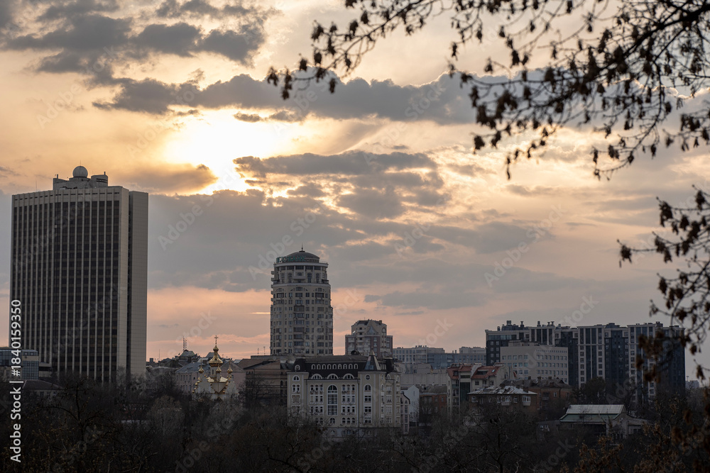 Fototapeta premium Dramatic sunset skyline with modern skyscraper and historical district
