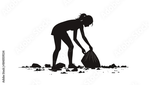 Silhouette of a young woman picking up trash into a bag, highlighting environmental responsibility and community cleanup efforts