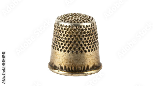 Antique metal thimble with dimpled texture on black background sewing needlework