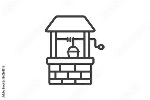 Traditional brick water well structure with roof and hanging bucket