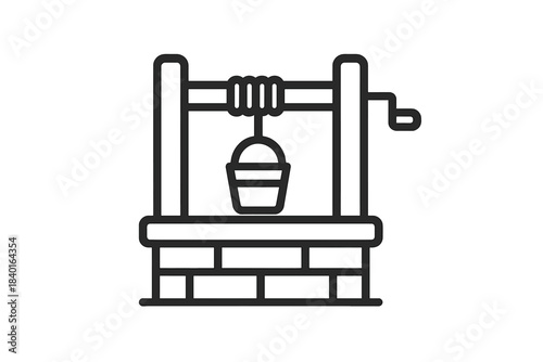 Traditional water well structure with a bucket hanging from the rope and a crank handle