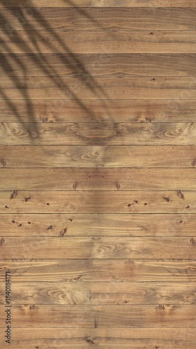 Vertical clip of shadow of palm leaf moving gently in wind on grey wood slats, summer wooden background, backdrop