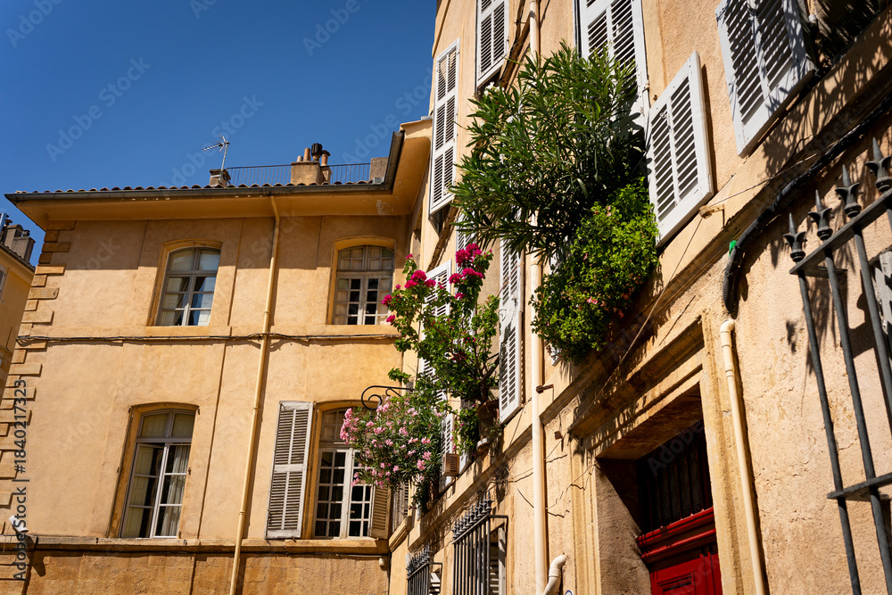 Fototapeta premium Provencal streets and buildings with traditional houses in southern France, Provence. Aix-en-Provence city on sunny summer day