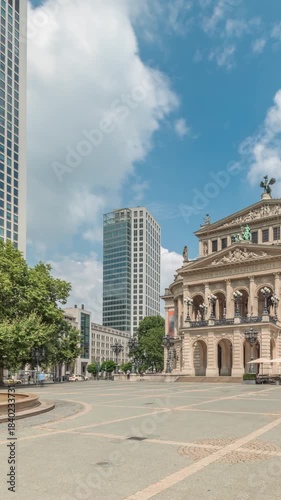 Hyperlapse of the Alte Oper (Old Opera) house in Frankfurt, a concert hall in Opernplatz. The square features a central fountain with people walking around, highlighting historic landmark timelapse