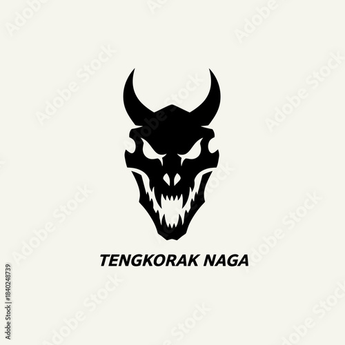 A black silhouette of a fearsome dragon skull with sharp teeth and glowing eyes, labeled 'TENGKORAK NAGA'.