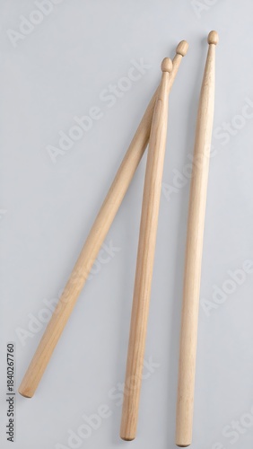 Three drum sticks on light background