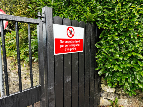 Fotografie No unauthorized persons beyond this point sign on a black gate in Knock Ireland