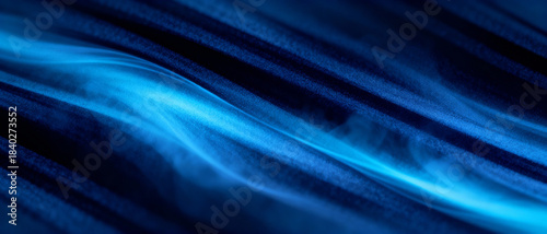 Blue abstract light wave flowing over dark textured background with dynamic motion and ethereal glowing energy effect
