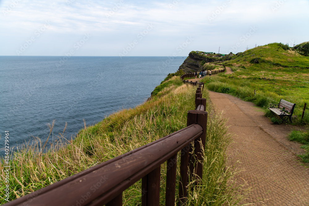 Obraz premium tranquil seascape with cliff and promenade at Songaksan in Jeju Island, South Korea