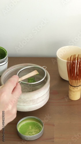 Sifting matcha powder. Step of preparation ceremonial matcha tea, minimalist aesthetic vertical