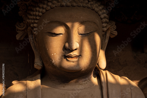 Seated Buddha Statue with Dappled Sunlight at Tapo Cliff Carvings in Anyue China