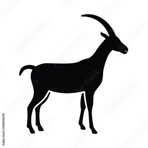 Black silhouette of a standing ibex or wild goat with long curved horns isolated on white