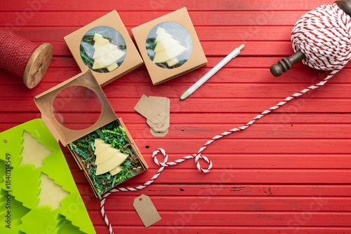 Homemade lotion bars molded into tree shapes using organic ingredients and placed in gift boxes