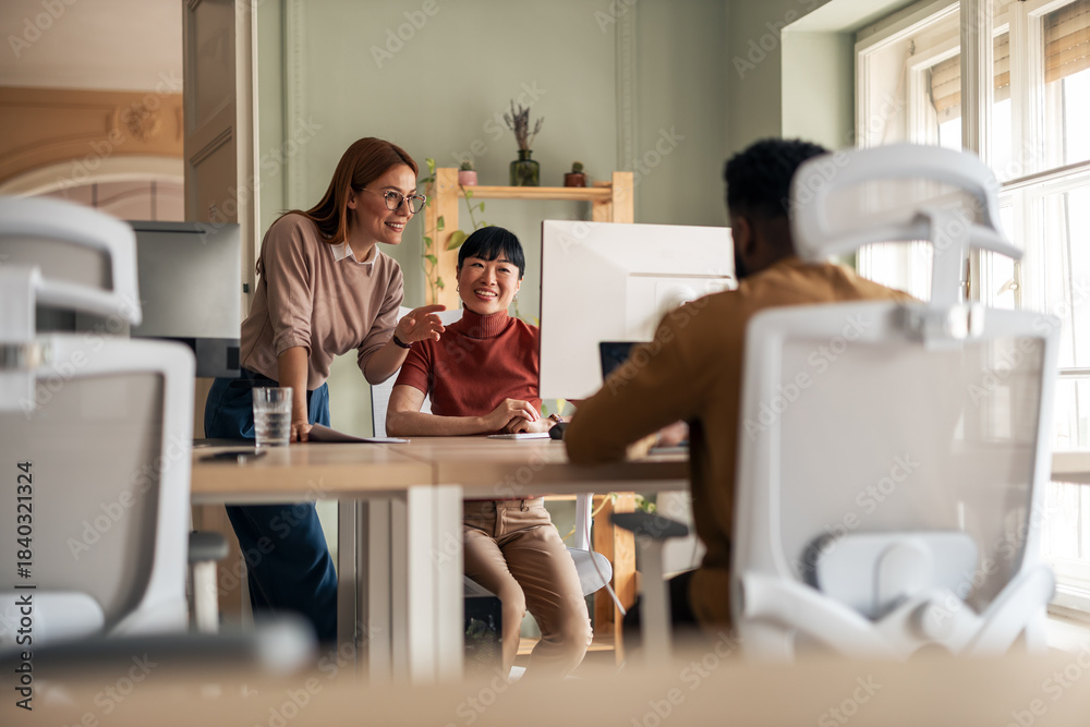 Obraz premium Diverse Team Collaborating on Ideas in a Modern Office Workspace