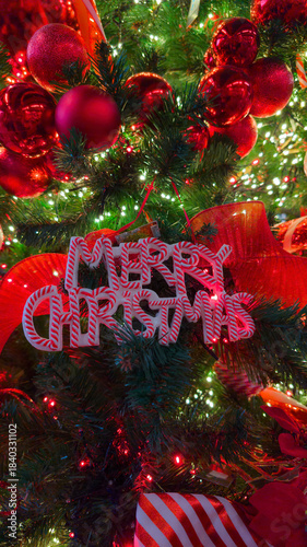 Festive Christmas Tree With Red Ornaments, Candy Cane Sign, And Warm, Sparkling Lights