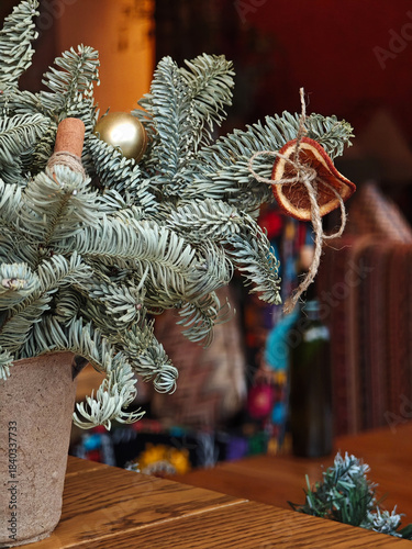 Christmas tree decor in warm public interior with close-up ornament details.