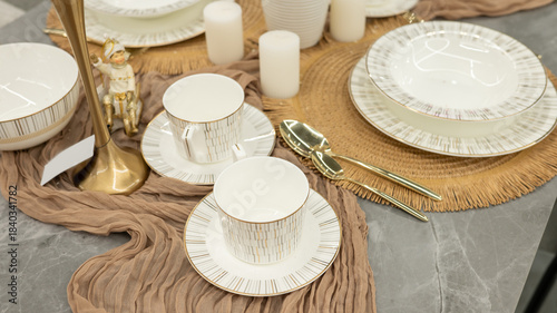 Elegant table setting with gold-rimmed china and decorative figurine