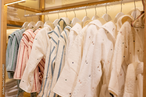 Wallpaper Mural Cozy bathrobes in neutral and pastel shades hanging neatly on wardrobe rack Torontodigital.ca