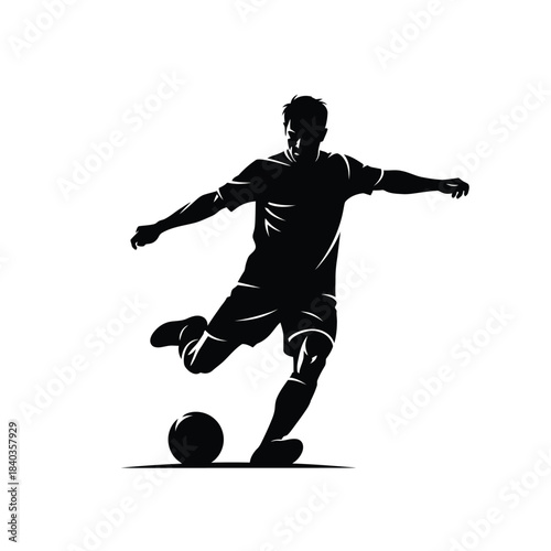 Silhouette of a soccer player kicking the ball in action