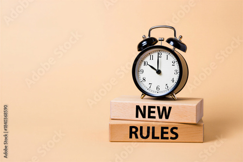 New Rules Concept with Alarm Clock on Wooden Blocks: Time for Change & Policy Updates
