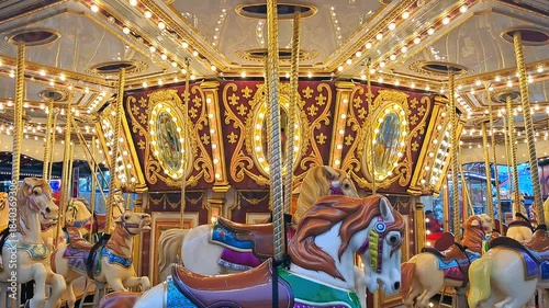 Toy horse carousel decorated for Christmas with sparkling lights and ornaments