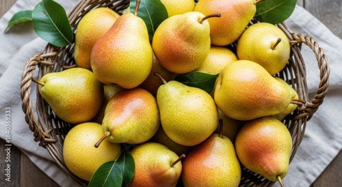 Woven basket overflowing with ripe Bartlett pears